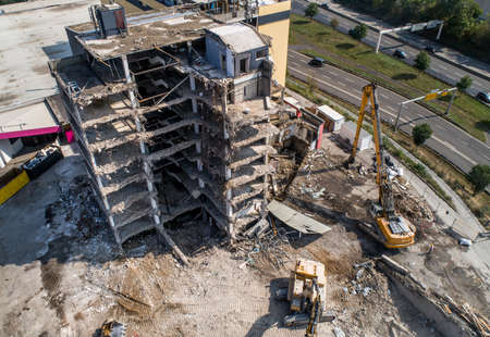 Aerial view of Building House Demolition and construction site Excavator with hydraulic crasher...