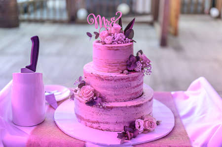 Beautiful wedding cake with cream With text MR MRS on top pink flowers roses.の写真素材