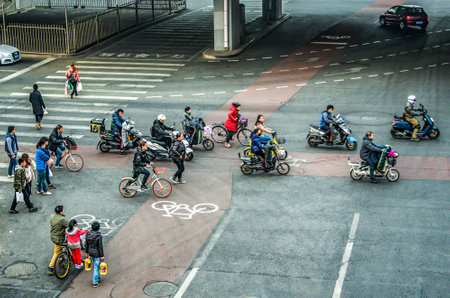 BEIJING China 23.02.2019 Pedestrians scooter and cyclists crossing the Bejing Street intersectionのeditorial素材