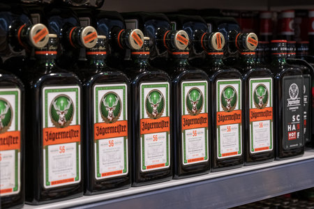 Andernach Germany 04.01.2020 Closeup rows of isolated bottles Jaegermeister spirit in shelf of german supermarketのeditorial素材