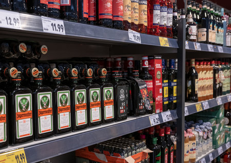 Andernach Germany 04.01.2020 Closeup rows of isolated bottles Jaegermeister spirit in shelf of german supermarketのeditorial素材