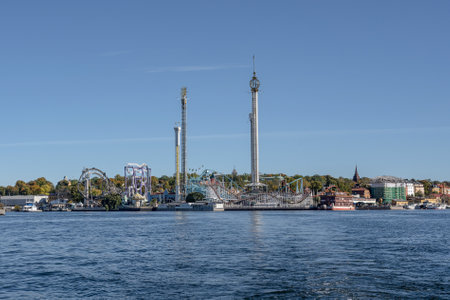 View of amusement park Grona Lund with carousels and tour rides on Djurgarden island Stockholm...
