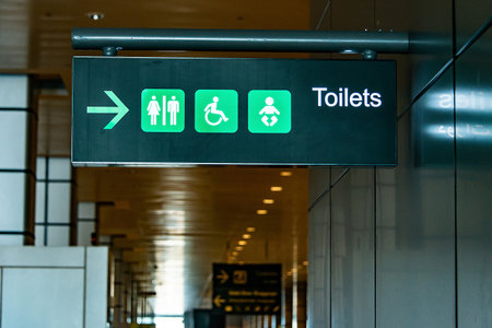 Toilet sign on the ceiling of entrance to bathroom in Airport Toilet sign concept. Icons set. Male and female restroomの写真素材