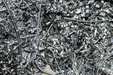Scrap Closeup twisted spiral steel shavings twisted metal from lathe machine In industrial plants