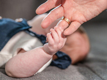 sweet tiny new born baby hand hold mum index finger. concept relationship between mother or parants and babyの写真素材