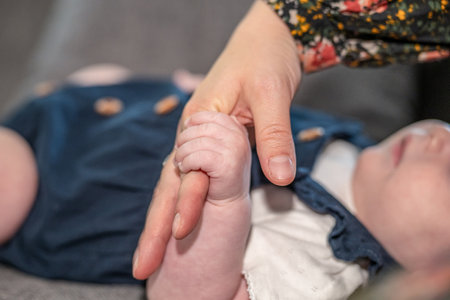 sweet tiny new born baby hand hold mum index finger. concept relationship between mother or parants and babyの写真素材