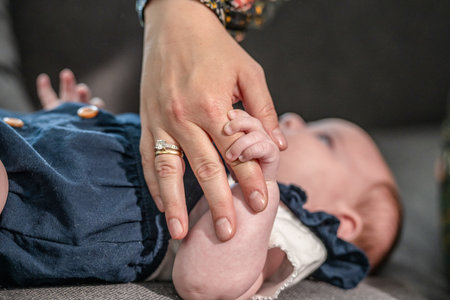 sweet tiny new born baby hand hold mum index finger. concept relationship between mother or parants and babyの写真素材