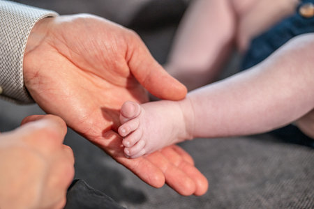 Baby feet in mother hands. Mom and her Child. Happy Family concept. Beautiful conceptual image of Maternityの写真素材