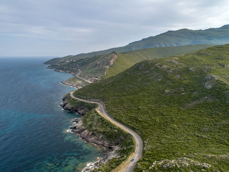 Aerial view car Roadtrip Winding road along rocky coast of Cap Corse peninsula on Corsica island Franceの写真素材