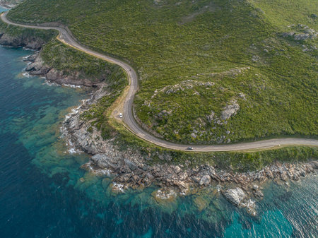 Aerial view car Roadtrip Winding road along rocky coast of Cap Corse peninsula on Corsica island Franceの写真素材