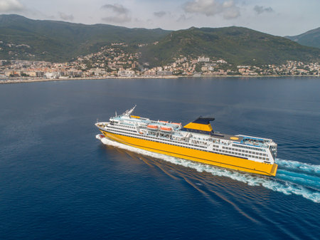 Big yellow passenger ferry goes on the Mediterranean Sea near Corsica island, France aerial view Cityscape Bastia portの写真素材