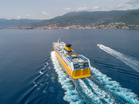 Big yellow passenger ferry goes on the Mediterranean Sea near Corsica island, France aerial view Cityscape Bastia portの写真素材