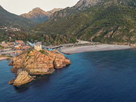 Aerial view town ruins Genoese tower of Porto Corsica France medieval watchtower Mediterranean Sea Calanches de Pianaの写真素材