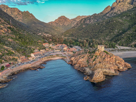 Aerial view town ruins Genoese tower of Porto Corsica France medieval watchtower Mediterranean Sea Calanches de Pianaの写真素材