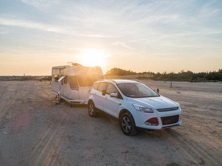 Camper rv caravan on mediterranean coast in Italy. Wild camping on sea shore. Holidays and travel in motor homeの写真素材