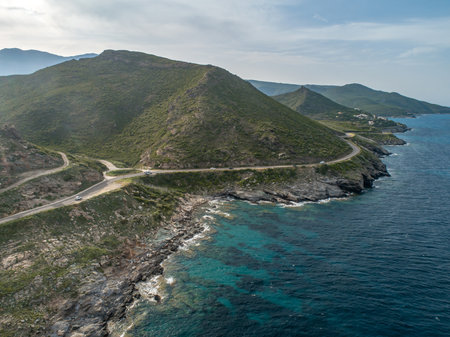 Aerial view car Roadtrip Winding road along rocky coast of Cap Corse peninsula on Corsica island Franceの写真素材