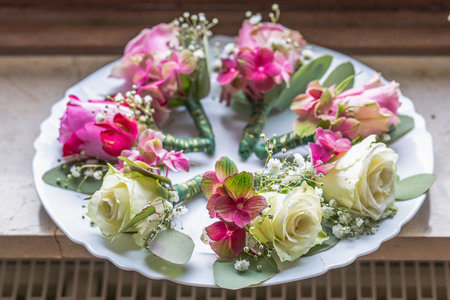 Small stylish boutonnieres on white marble plate, flat lay colorful many groomの写真素材