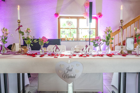 Wedding decor. Close up of a wedding table decoration with white and pink flowers and candles Wedding floristic conceptの写真素材