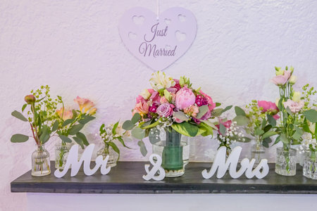 Wedding decor. Close up of a wedding table decoration with white and pink flowers and candles Wedding floristic conceptの写真素材
