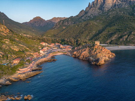Aerial view town ruins Genoese tower of Porto Corsica France medieval watchtower Mediterranean Sea Calanches de Pianaの写真素材