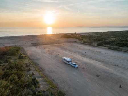 Camper rv caravan on mediterranean coast in Italy. Wild camping on sea shore. Holidays and travel in motor homeの写真素材