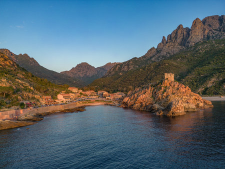 Aerial view town ruins Genoese tower of Porto Corsica France medieval watchtower Mediterranean Sea Calanches de Pianaの写真素材