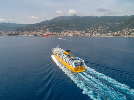 Big yellow passenger ferry goes on the Mediterranean Sea near Corsica island, France aerial view Cityscape Bastia portの写真素材