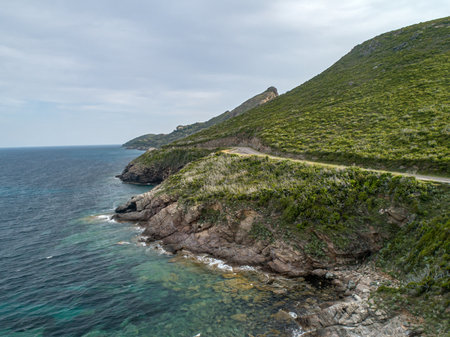 Aerial view car Roadtrip Winding road along rocky coast of Cap Corse peninsula on Corsica island Franceの写真素材