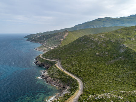 Aerial view car Roadtrip Winding road along rocky coast of Cap Corse peninsula on Corsica island Franceの写真素材
