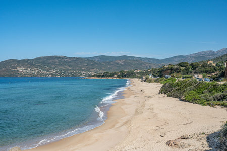 Spectacular view at Sagone Corsica France beautiful sand Beach boats mountain village Tourism and vacations conceptの写真素材
