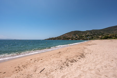 Spectacular view at Sagone Corsica France beautiful sand Beach boats mountain village Tourism and vacations conceptの写真素材