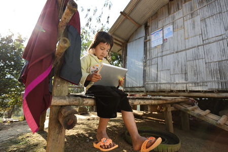 Chiang Mai Thailand  December 28 2012: Little girl using tabletのeditorial素材