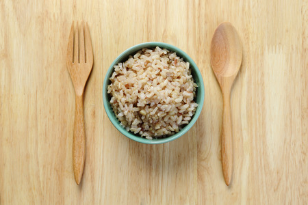 Brown Rice on Wooden Tableの写真素材