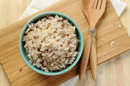 Brown Rice on Wooden Plate Brown Rice on Wooden Plate