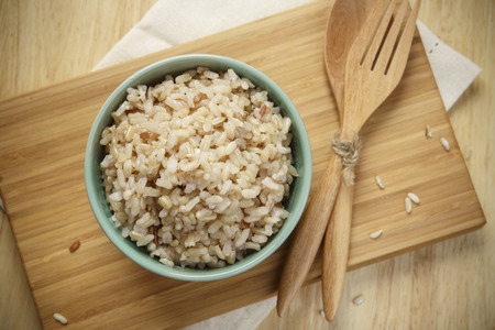 Brown Rice on Wooden Plate Brown Rice on Wooden Plate