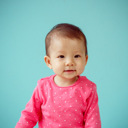 Asian baby girl wearing pink clothingの写真素材