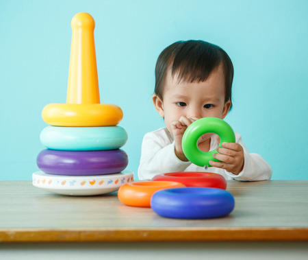 kid boy playing with building blocks at home or kindergartenの写真素材