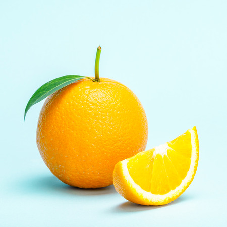 Orange fruit slice isolated on blue background.の写真素材