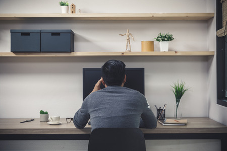 Young male freelancer with computer in room area, Man working at the desk, Freelance artist creative 
designer illustrator graphic skill lifestyle conceptの写真素材
