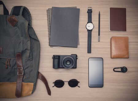 Traveler's accessories with passport, books of travel plan, wallet, camera, campass, backpack and...