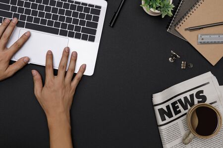 Top view workspace office supplies mockup with hands using notebook, hot coffee cup, glasses, books,...