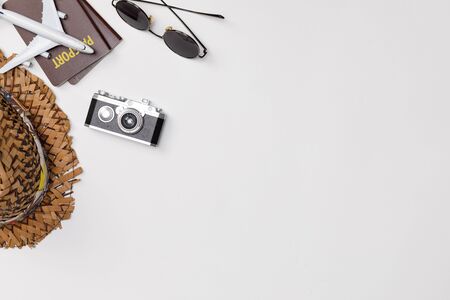 Top view mockup of Traveler's accessories with passport, camera, hat  and airplane toy isolated...