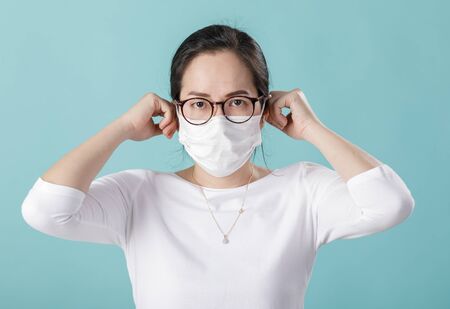 Asian young woman wearing respirator mask to protect coronavirus outbreak and washing hands  alcohol...