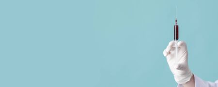 holding testing patients blood samples for Coronavirus Outbreak (COVID-19) in laboratory, New coronavirus 2019-nCoV from   concept, Empty  isolated on blue panorama bannerの写真素材