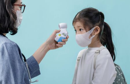 Mom and Asian little child girl wearing respirator mask to protect coronavirus outbreak and body...