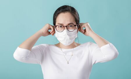 Asian young girl is wearing medical face masks to protect themselves from pollution flu virus, Nの写真素材