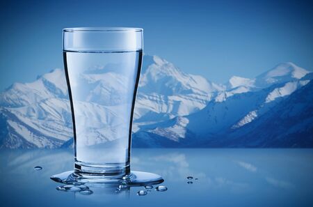 Mineral water in a glass with water drops in the iceberg background, Healthcare and beauty hydration conceptの写真素材