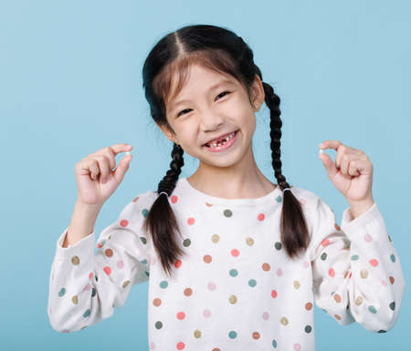 Closeup child girl smiling with loose teeth, Dentistry and Health care concept