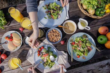 Table with a variety of vegetables in a plate, set for a delicious and healthy meal in a restaurant with salad, dinner, and buffet options, perfect for a wedding banquet or party celebrationの写真素材