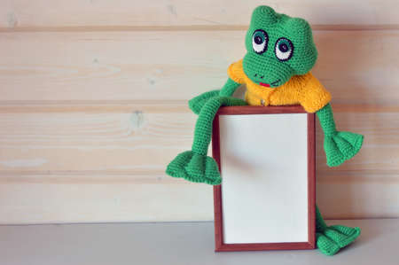 Amigurumi doll green Frog with a mockupの写真素材